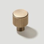 plank-hardware-cabinetry-lennon-grooved-button-knob-antique-brass-29997609844834